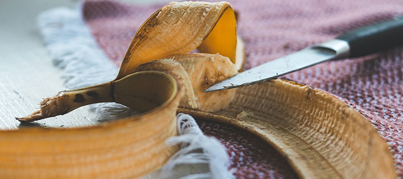 Knife cutting banana peels to use in compost pile as a gardening myth